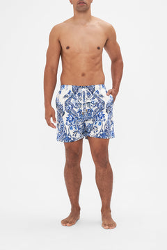 Front view of model wearing Hotel Franks By CAMILLA blue and white mens boardshorts in Glaze and Graze print